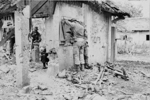 Troops of 5RAR searching ruined buildings after a battle with the North Vietnamese Army, Binh Ba, June 1969