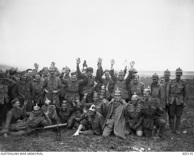 Australian soldiers sporting helmets and cups captured in the battle of Pozières