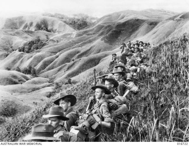 Having advanced through the rugged Finisterre Ranges, these soldiers rest before continuing to the Japanese-held village of Bogodjim