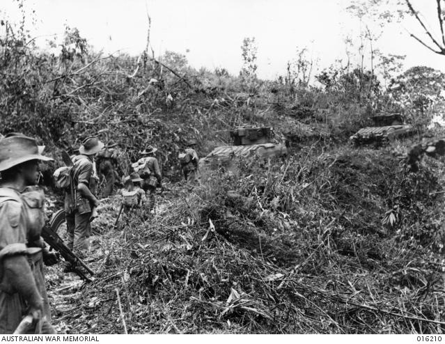 Troops move in behind Matilda tanks for a dawn attack on the Japanese-held villageof Sattelberg.