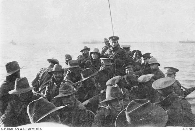 A view looking aft of lifeboat carrying unidentified men of the Australian 1st Divisional Signal Company as they are towed towards Anzac Cove at 6 am on the day of the landing.