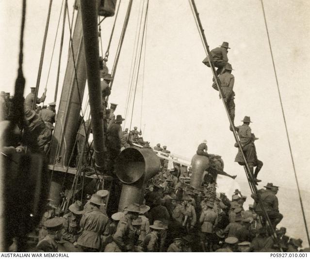 Troops on the deck of HMT Ascot (A33) watching the bombardment whilst being transported to Anzac Cove on 25 April 1915.