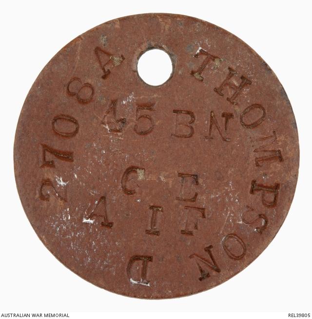 circular disc with a hole at the top to secure to a green octagonal disc and impressed with 2708A THOMPSON D 45 BN CE