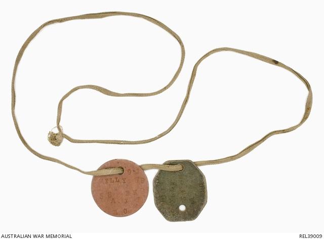 a length of khaki cotton tape with a circular and an octagonal disc threaded onto it worn by William Dickinson Reily, 56th Battalion.