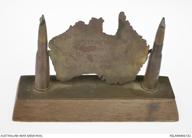 Trench art watch stand with a wooden base