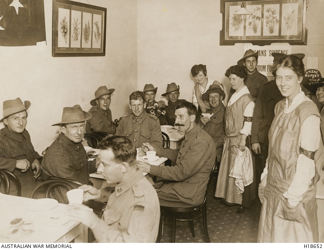 Australian soldiers partaking refreshments from an Anzac Buffet in Victoria Street.