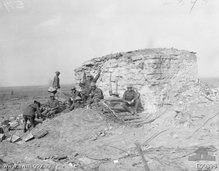 Australian troops resting behind a conspicuous pillbox, south east of Anzac Ridge in the Ypres sector, 26 September 1917