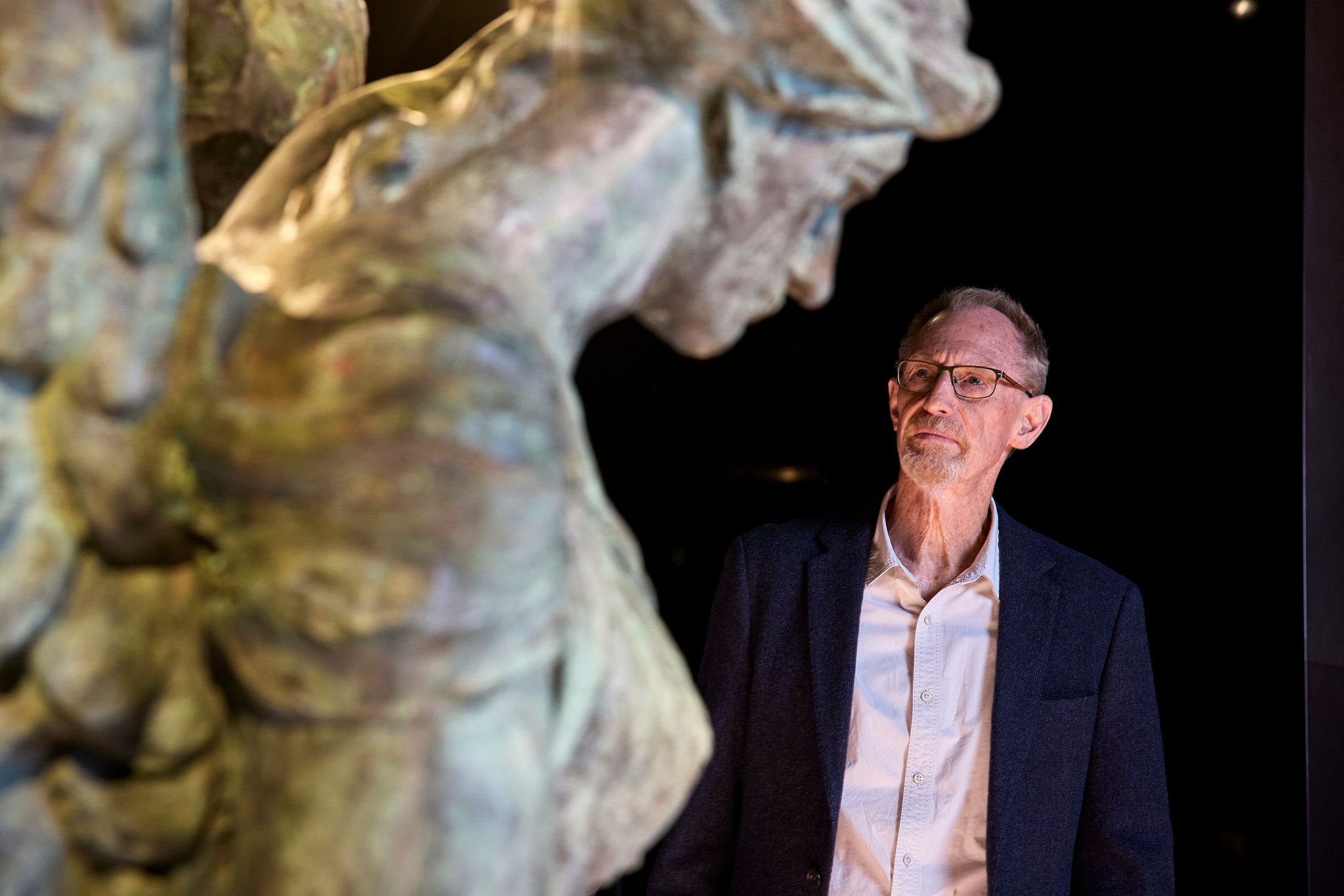 Man looking at the Winged Victory sculpture