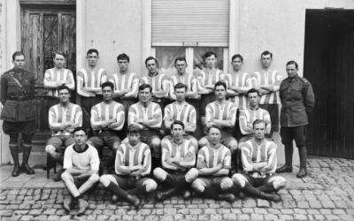An outdoors group portrait of unidentified members of the Australian Rules Football Team of the 1st Australian Division.