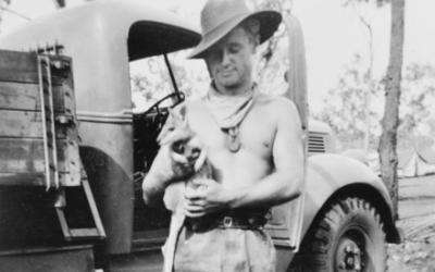 A member of the Second AIF wearing his compressed fibre identity discs, Australia c 1944.