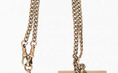 This 9 carat gold pocket watch chain carries two fobs. The horizontal bar was designed to be inserted into a waistcoat buttonhole, thus securing the chain, while the watch would have been attached to one of the left hand clips. 
