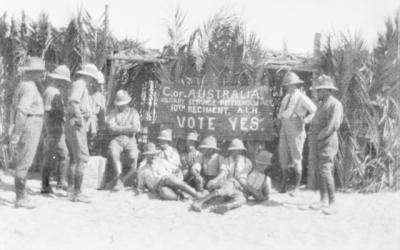 Soldier in front of a banner urging people to vote yes to conscription