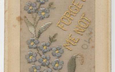 Embroidered silk postcard made in France during the First World War. This postcard features blue forget-me-nots