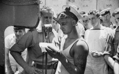 ON BOARD H.M.A.S. PERTH, IN THE MIDDLE EAST, WHEN THE AUSTRALIAN BROADCASTING COMMISSION'S FIELD UNIT WAS MAKING A RECORDING OF THE MEN'S VOICES FOR A BROADCAST TO AUSTRALIA.
