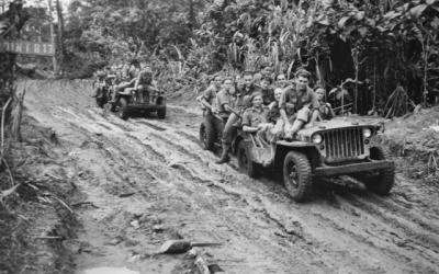BOUGAINVILLE. 1945-07-18. TROOPS OF 58/59 INFANTRY BATTALION, LOADED INTO JEEPS AND TRAILERS MOVING ALONG THE MUDDY BUIN ROAD EAST OF THE OGORATA RIVER.