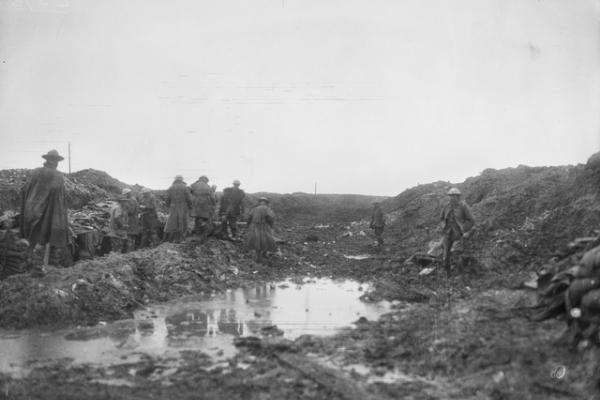Soldiers make their way through the muddy Somme landscape