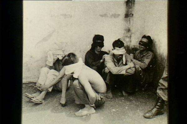 Blindfolded Viet Cong suspects awaiting interrogation, Duc Thon, November 1966