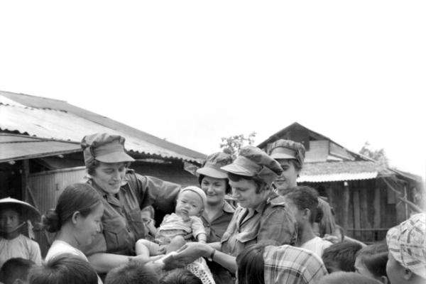 Australian Army Nursing Corps members and Vietnamese villagers, Hoa Long, June 1967