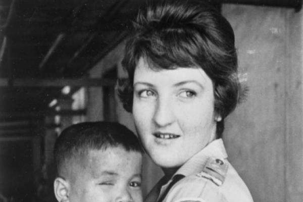 Australian Red Cross nurse Carol Eacott with a Vietnamese orphan, January 1970