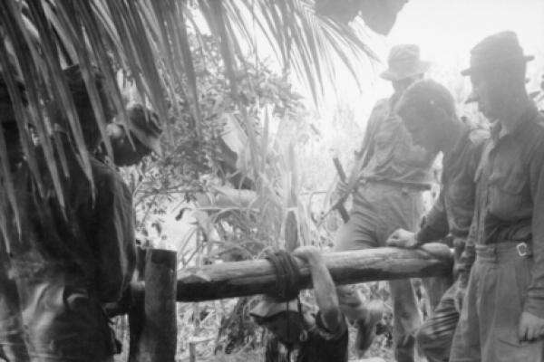 Entering a Viet Cong tunnel system through a water well, Xam Cay Xaoi village, Bien Hoa province, 1965