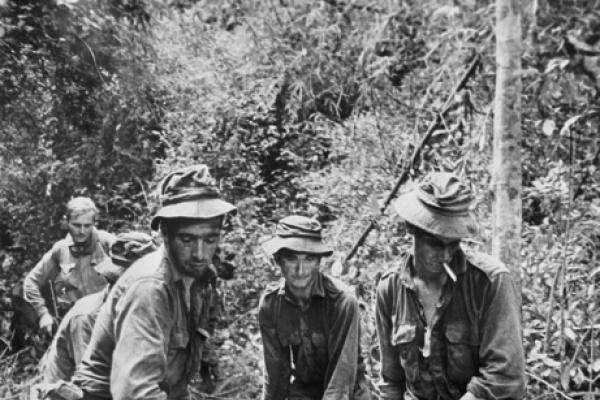 Carrying a wounded Australian soldier in a stretcher to a helicopter pick up point, 1970