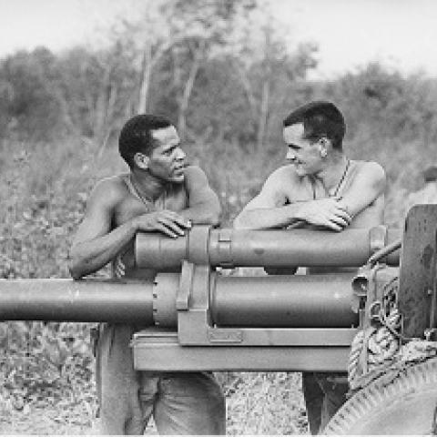 Aboriginal soldier, Bombardier John Burns of Holland Park, Qld (left), speaks with Gunner Bruce Morris of Morwell