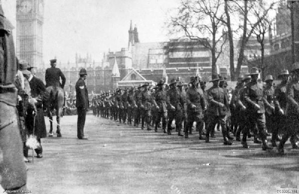 Australian 1st Division troops march through the London streets on the anniversary of the first Anzac Day. Big Ben and The Houses of Parliament can be seen in the left background (P03330.001)