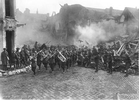 Band of the 5th Australian Infantry Brigade passing through the Town Square of Bapaume on 19 March, playing the 'Victoria March'.