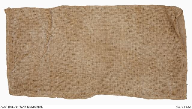 Brown German ersatz (substitute) sandbag made from paper twisted into strands, then woven. The bag is sewn together with cotton tread.