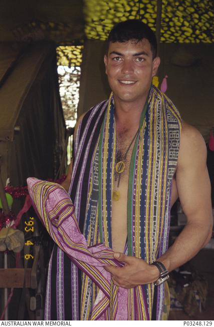 Ben with the tais given to him in East Timor, 1999. (Wendy Sharpe, AWM P03248.129)
