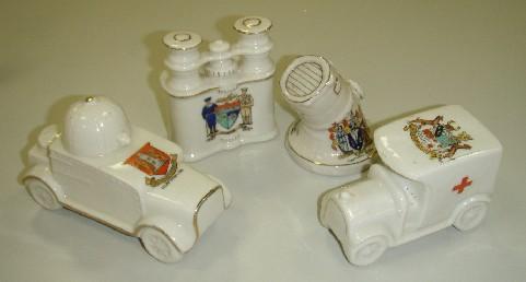 Crested china vehicles and military equipment, including an armoured car (REL23596), set of binoculars (REL23600), searchlight (REL23601) and ambulance (REL23599).