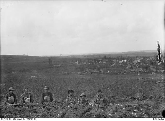 The left-side view of the village of Le Hamel, showing Australian soldiers in the recently-captured German positions. E02844A