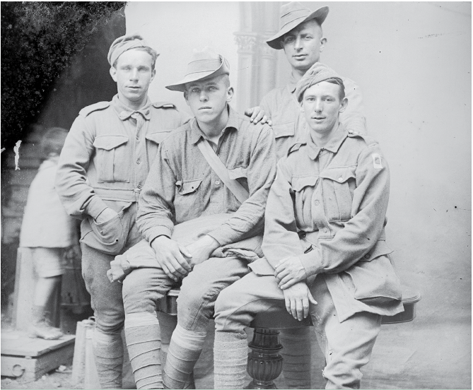 Australians in France quickly made friends with the newly arrived American troops. Here, in a group of men resting at Vignacourt in 1918, two Australians have swapped headwear with two Americans before facing the camera. 