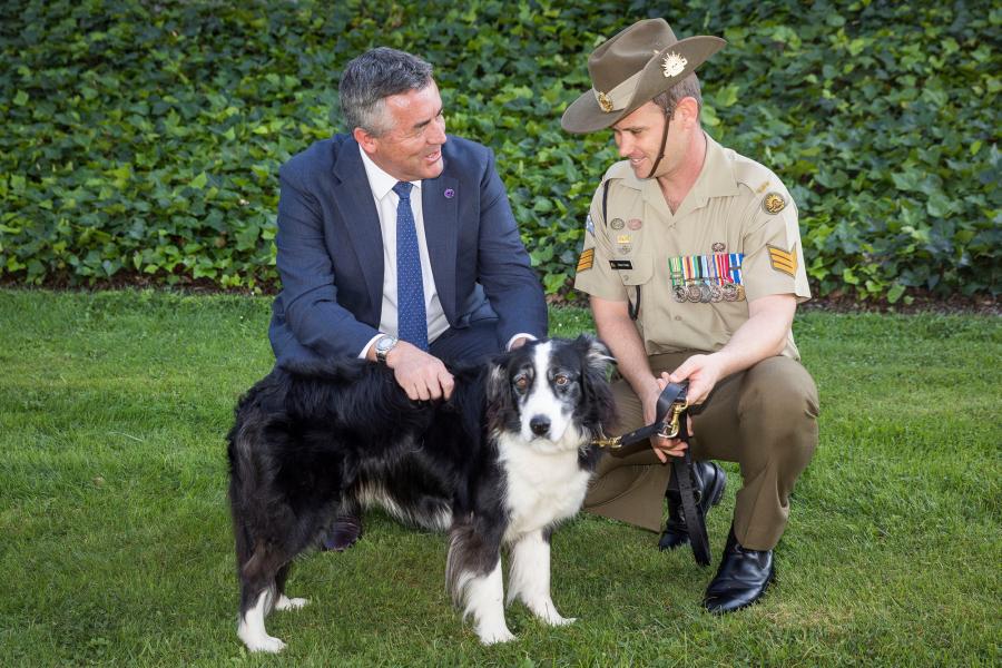 Sergeant Stuart Conlin with his dog Trip and Minister Darren Chester