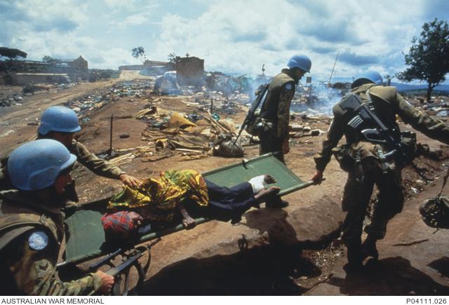 Australians carry an injured Rwandan women after the massacre (photo George Gittoes)