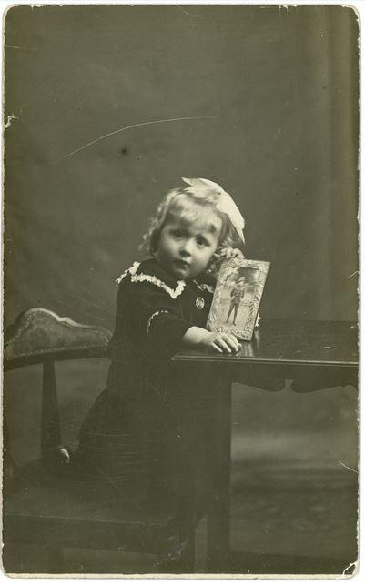 Vera with the portrait of her father.