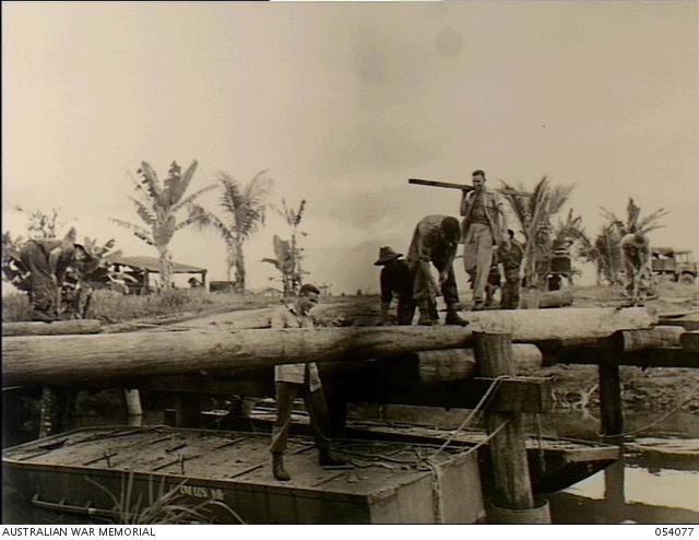 Milne Bay, New Guinea. 1943-07-12. Members of the 21st Field Company, Royal Australian Engineers, building a new bridge across Lauiam Creek as the previous one had fallen down.