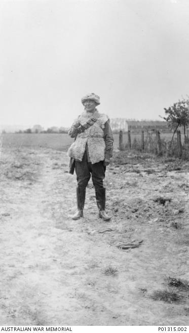 Warrant Officer Harry Hoyling (of Chinese descent) wearing a sheepskin jacket and a gas respirator, France, 1916. AWM P01315.002