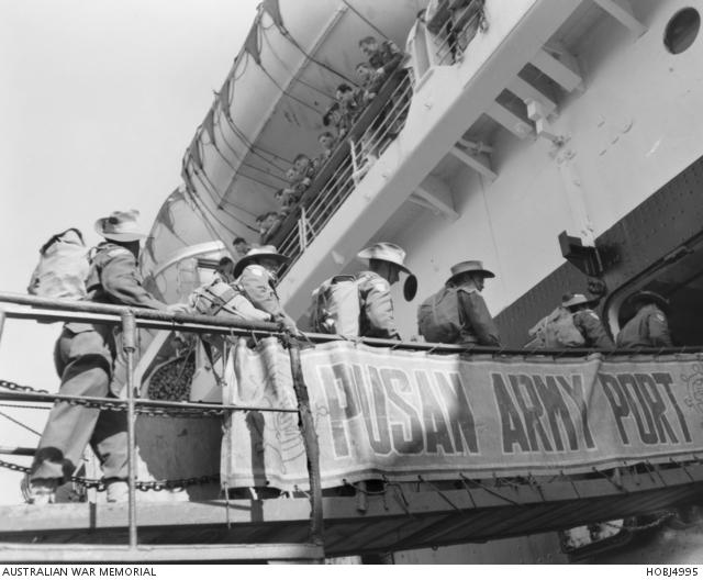 A group of soldiers of the 2nd Battalion, The Royal Australian Regiment (2RAR), boarding the SS New Australia for their trip home to Australia.