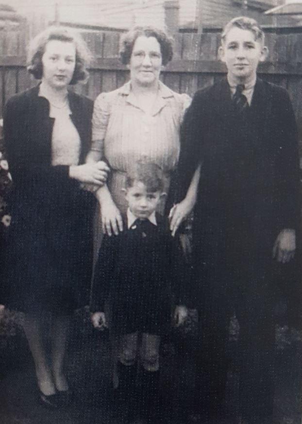 John with his mother, sister and brother in Melbourne near the start of the war