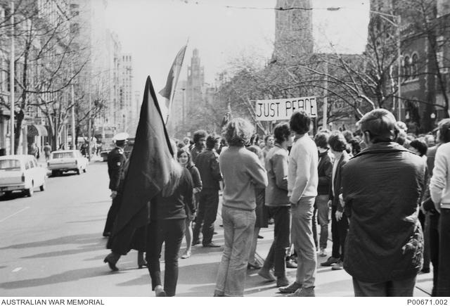 Crowd assembling on Collins Street, Melbourne, for a Vietnam march 1970. AWM P00671.002