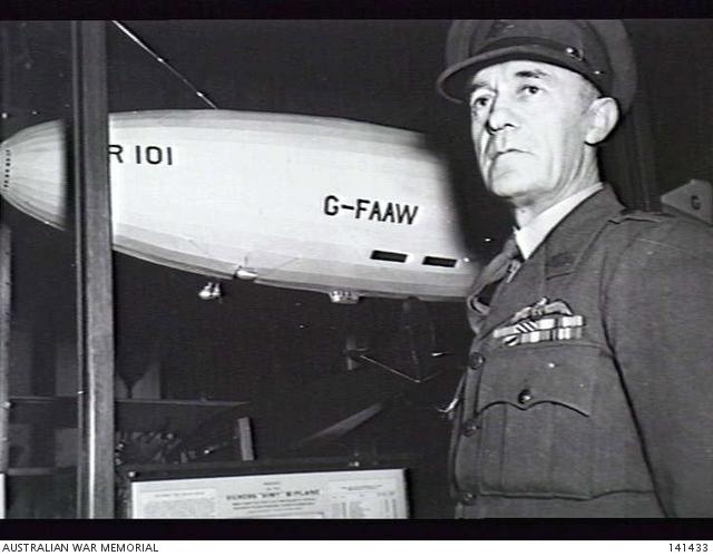 Major J. D. E. Shotter in front of the model of the ill-fated British Airship R101. Major Shotter was the Engineer Officer of the R34, the sister ship of the R101, the R34 made her record crossing of the Atlantic in 1919.  