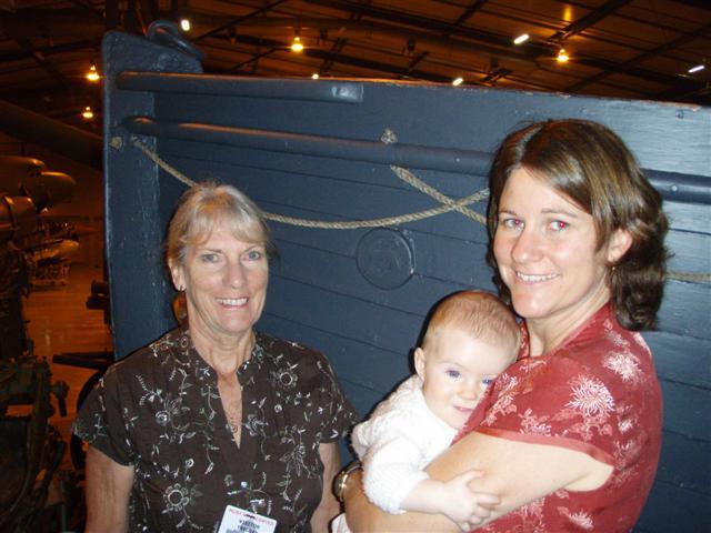 The three generations: Christine, Natasha and six month old Rose Devanha beside the nameplate on the now one hundred and three year old Devanha lifeboat.