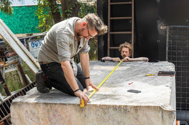 Artist Alex Seton and assistant, Mitchell Ferrie measuring the marble block for cutting.