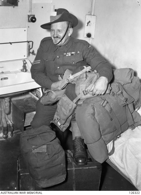 Different voyage - a soldier (Cpl Howes MM) sitting on his assigned bunk on board the ship: photo 126322. 
