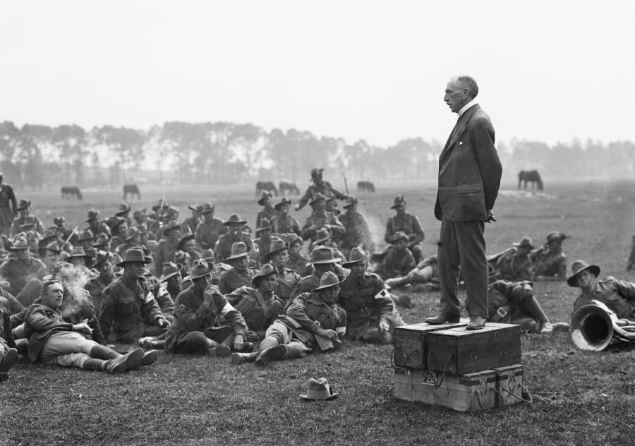 The Australian Prime Minister, Right Honourable William Morris (Billy) Hughes (standing on four ammunition boxes), addressing the Australians, about one and a half miles from Amiens.