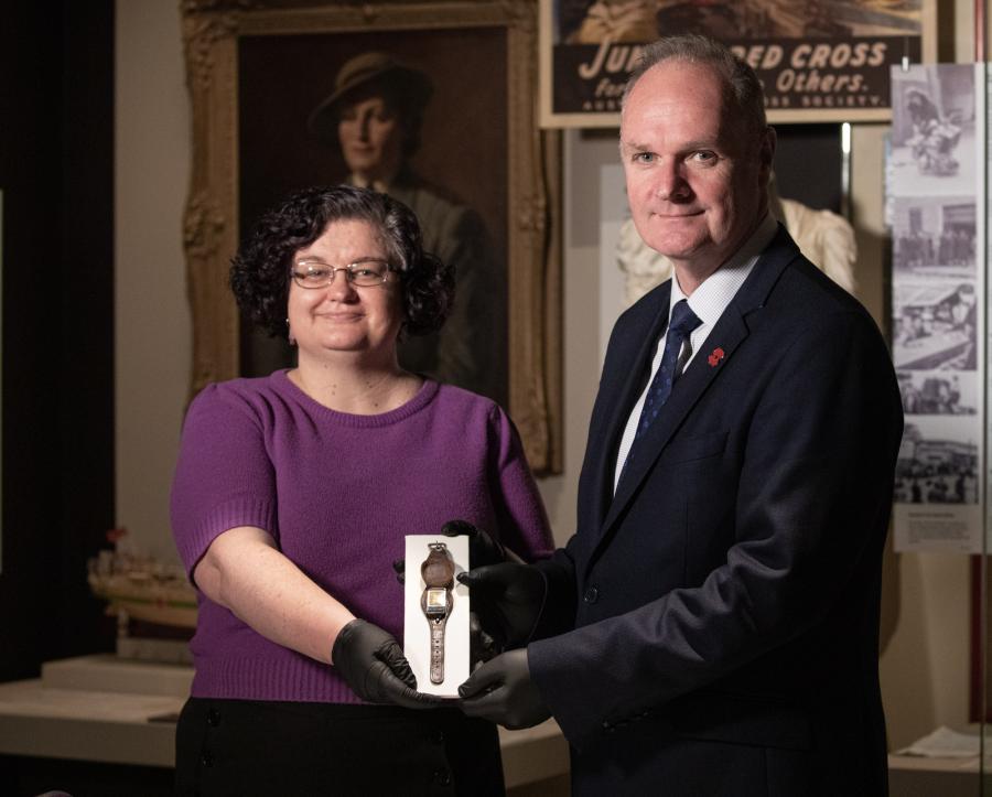 Curator Di Rutherford and Director Matt Anderson hold the watch from AHS Centaur