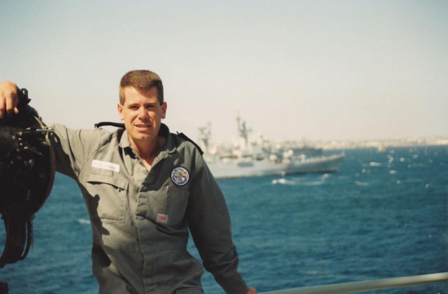 Perryman on the flagdeck of Tobruk with coalition warships in the background.