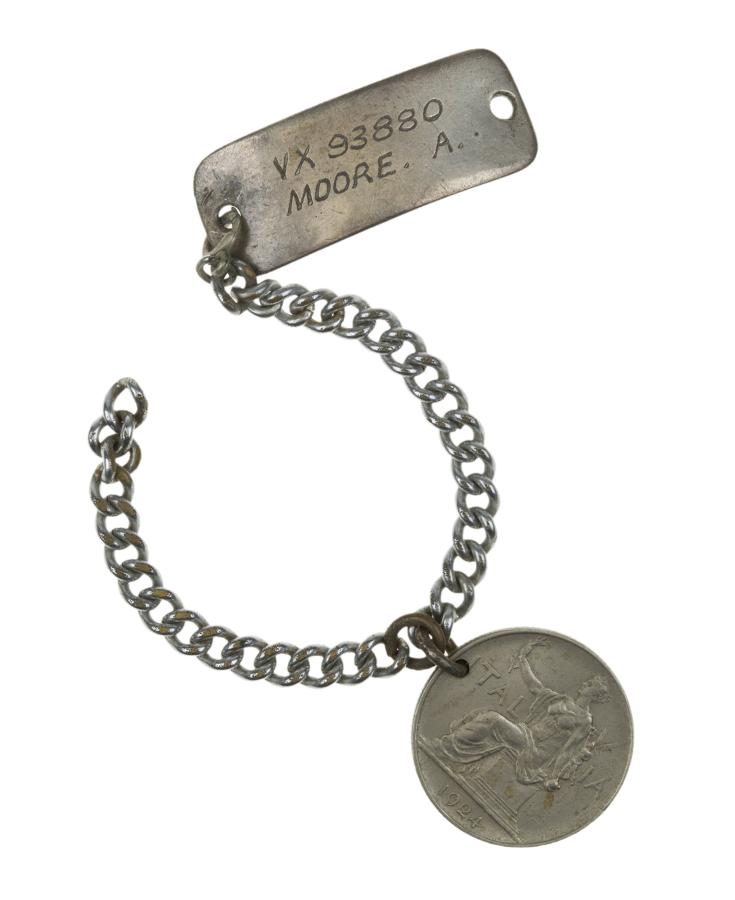 Identity bracelet worn by Lieutenant Alan Moore, inscribed with his name, rank, service number, and status as an official war artist. The 1924 one lira coin was probably attached in 1944 or 1945, when Moore was covering RAAF squadrons in Italy. Moore was probably wearing this bracelet at the liberation of Belsen.  Donated by Mrs Alison Moore in memory of Alan Moore