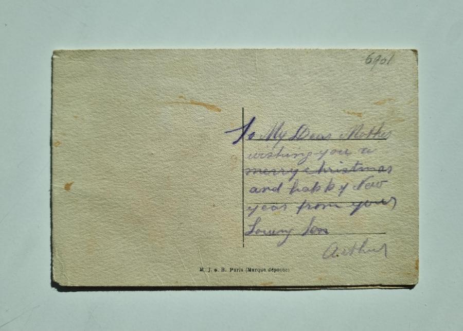 Back of embroidered postcard with "Happy New Year" writing